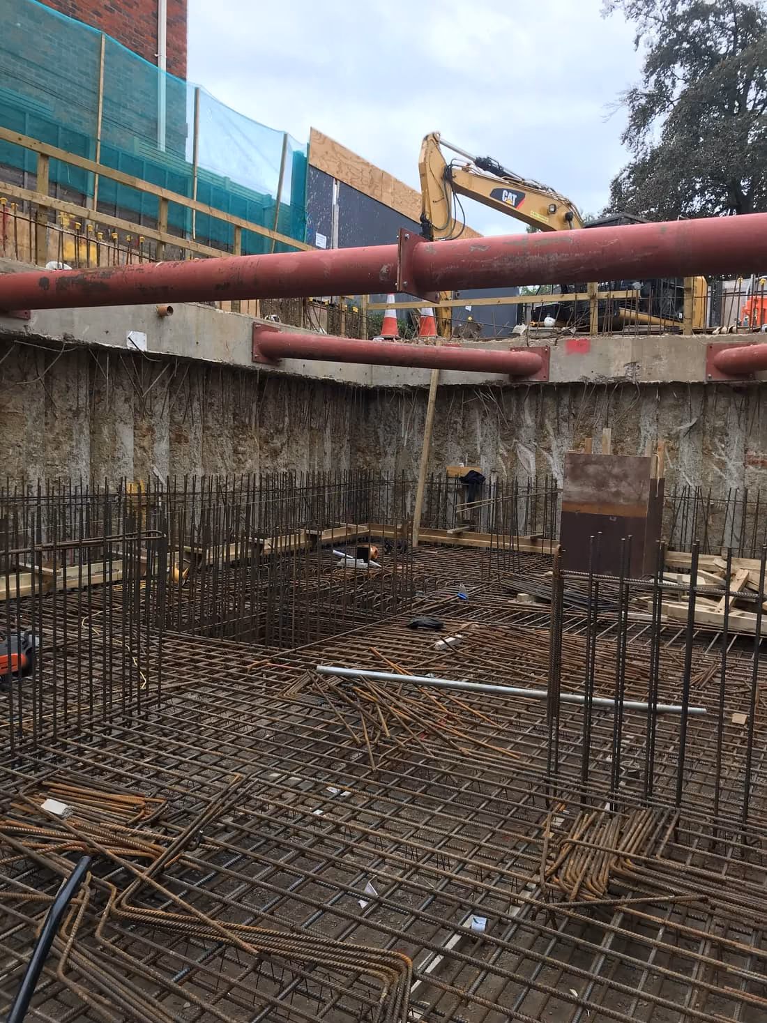 Steel reinforcement and formwork for a new foundation slab during groundworks in London
