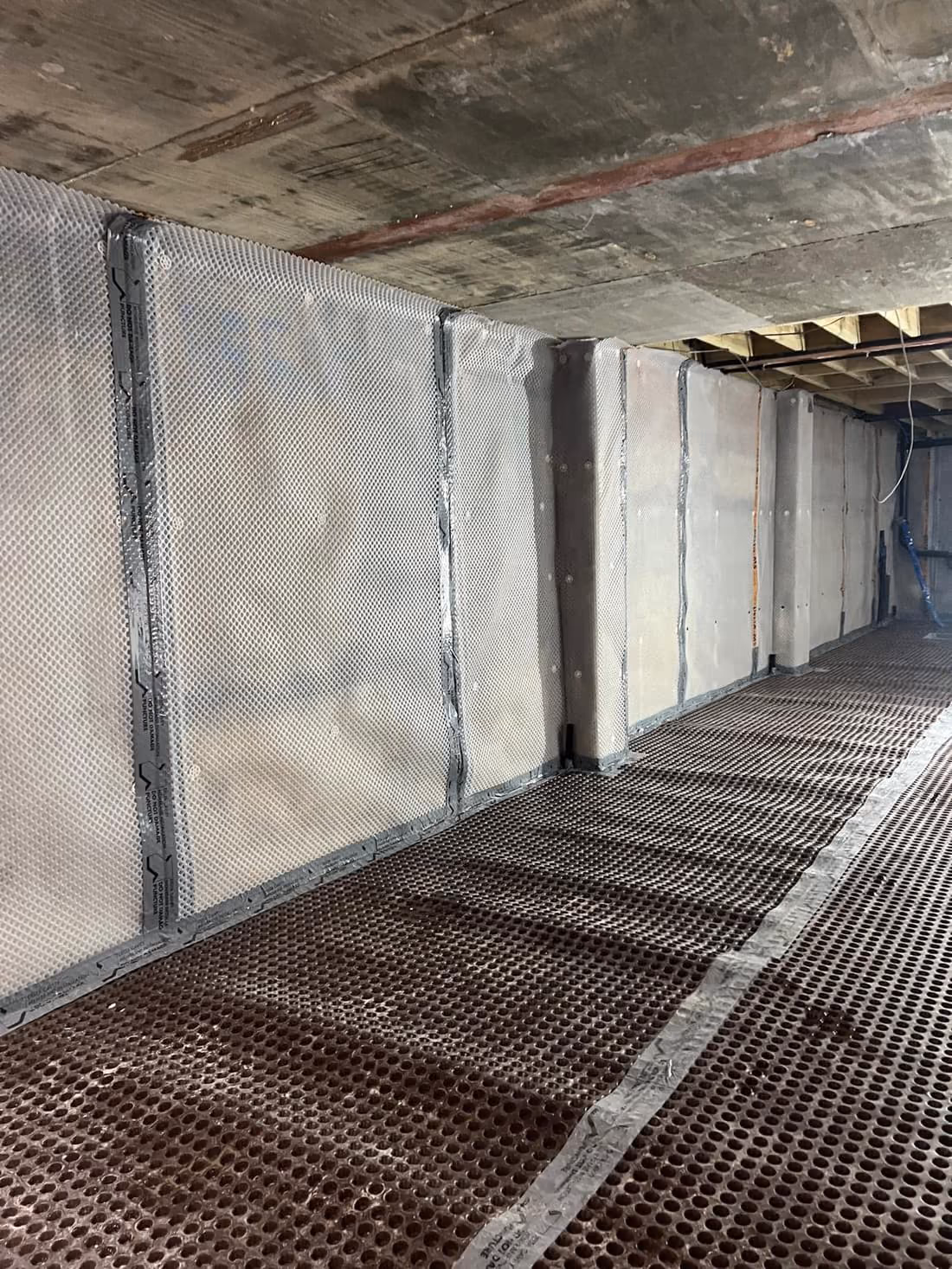 Completed reinforced concrete basement structure with perimeter drainage in London