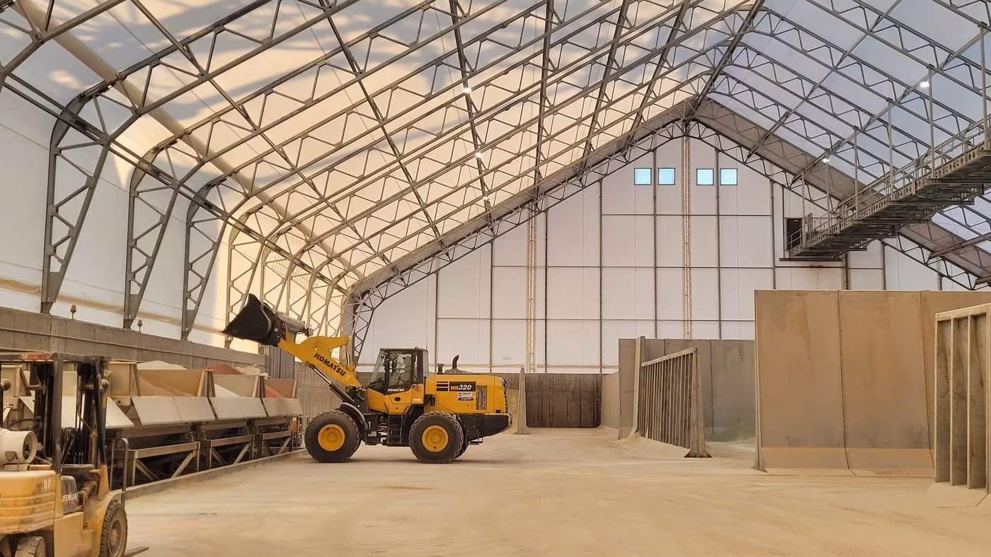 Interior of a Calhoun engineered fabric building with a free-span steel frame and natural daylight, used for bulk storage