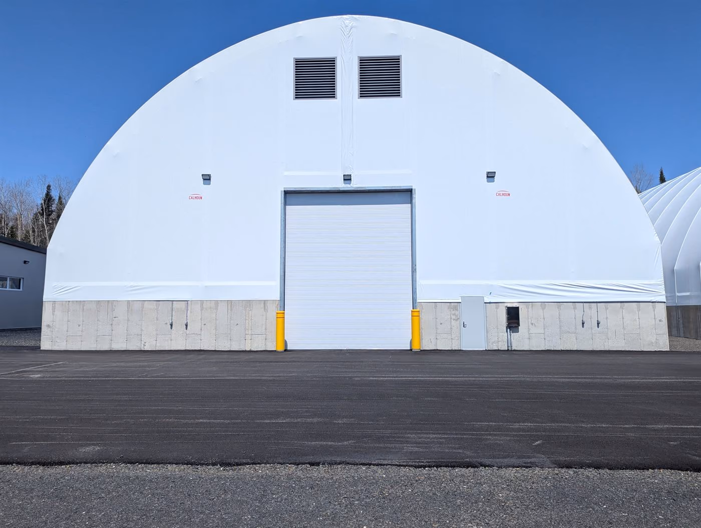 Large Calhoun fabric dome with concrete base and roller door for bulk storage