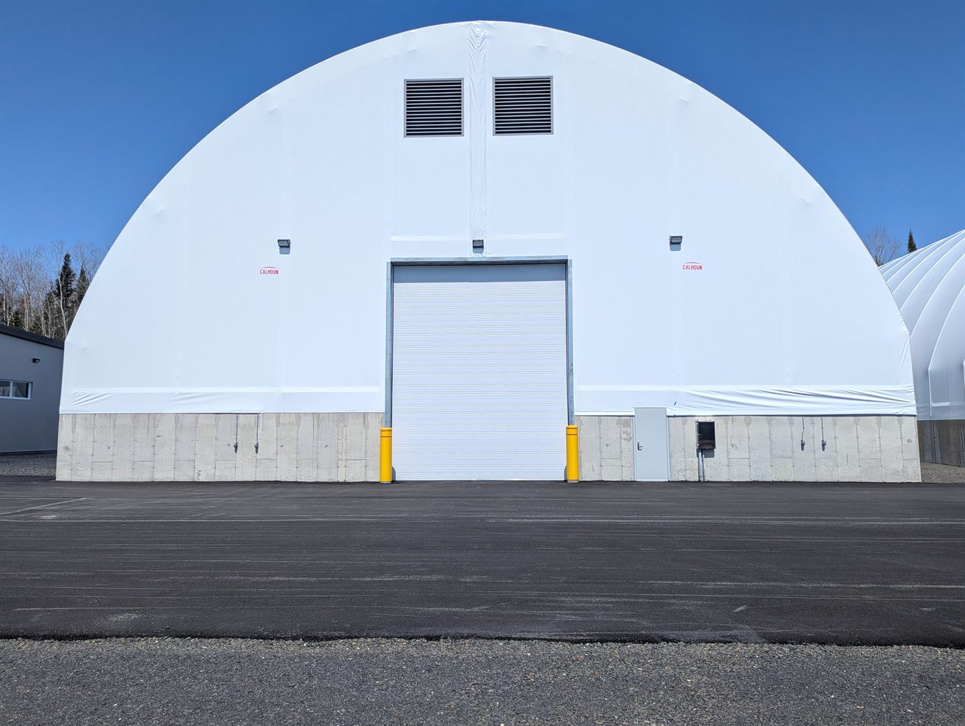 Large Calhoun fabric dome with concrete base and roller door for bulk storage