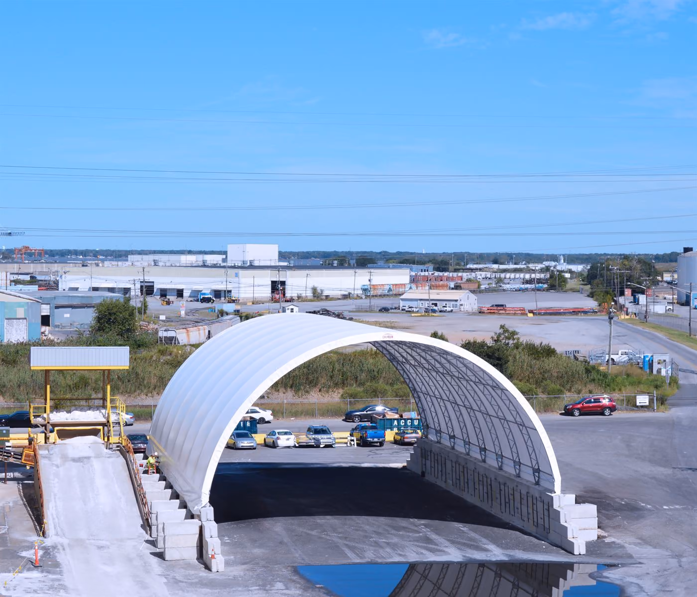 Open-ended Calhoun fabric structure with concrete push-walls at a commercial yard