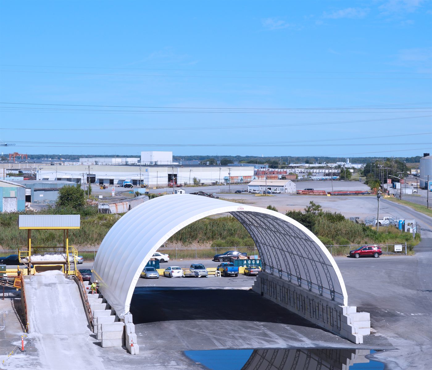 Open-ended Calhoun fabric structure with concrete push-walls at a commercial yard