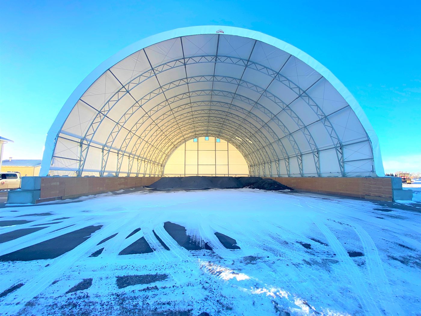 Calhoun fabric dome with concrete-block walls used for salt and sand storage