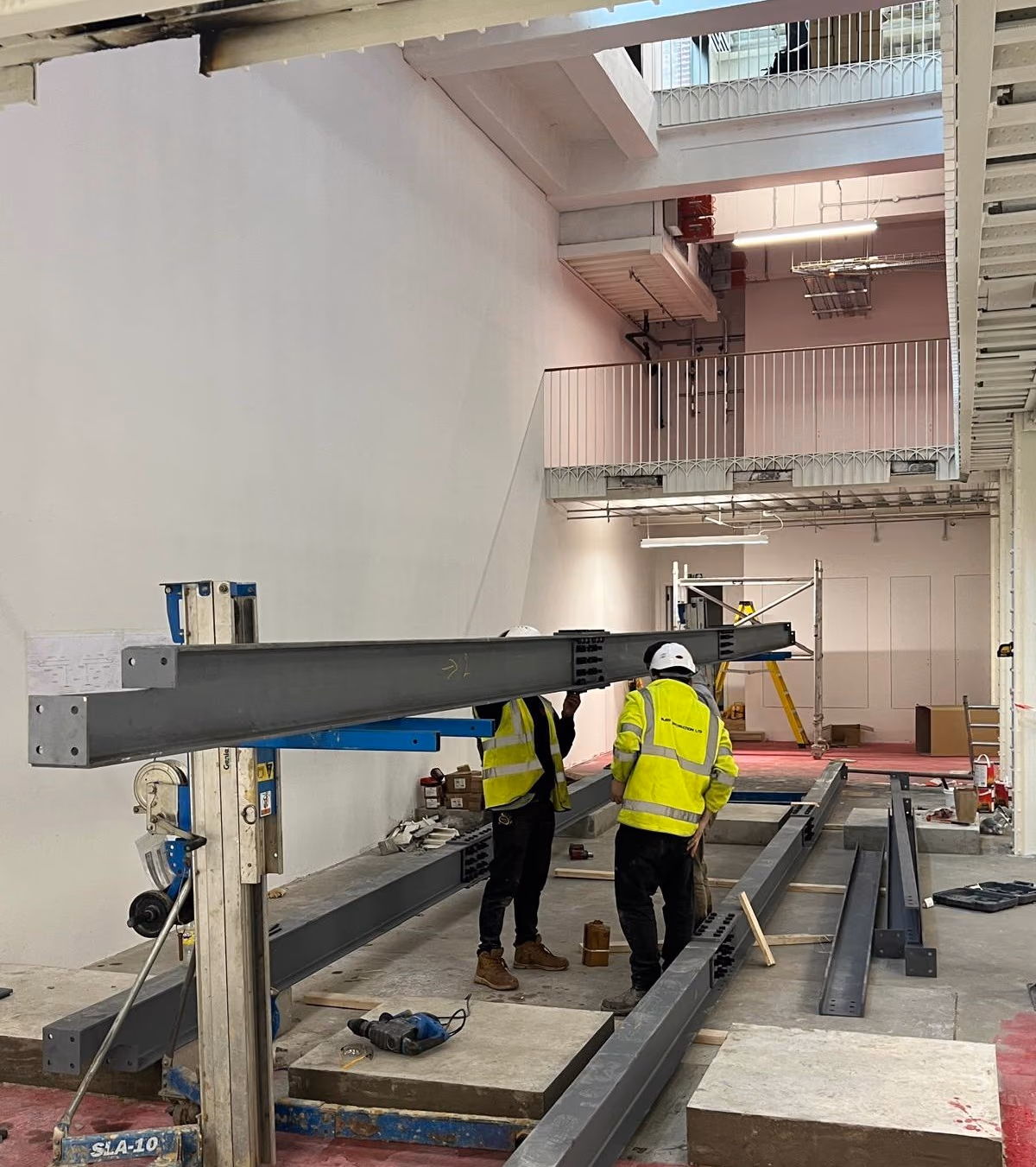 EMA Structures site team installing new steel beams for a mezzanine floor inside a London building