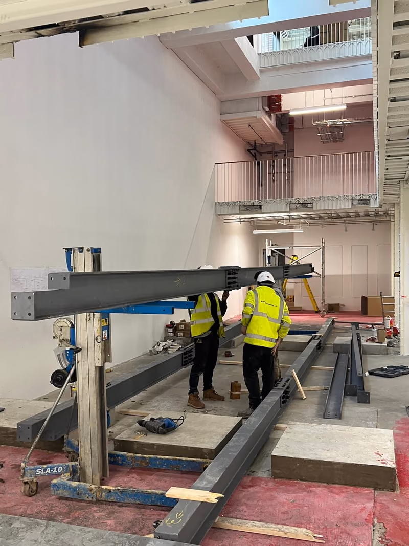 Steel beams for a new mezzanine floor being lifted into place inside the Short's Gardens building
