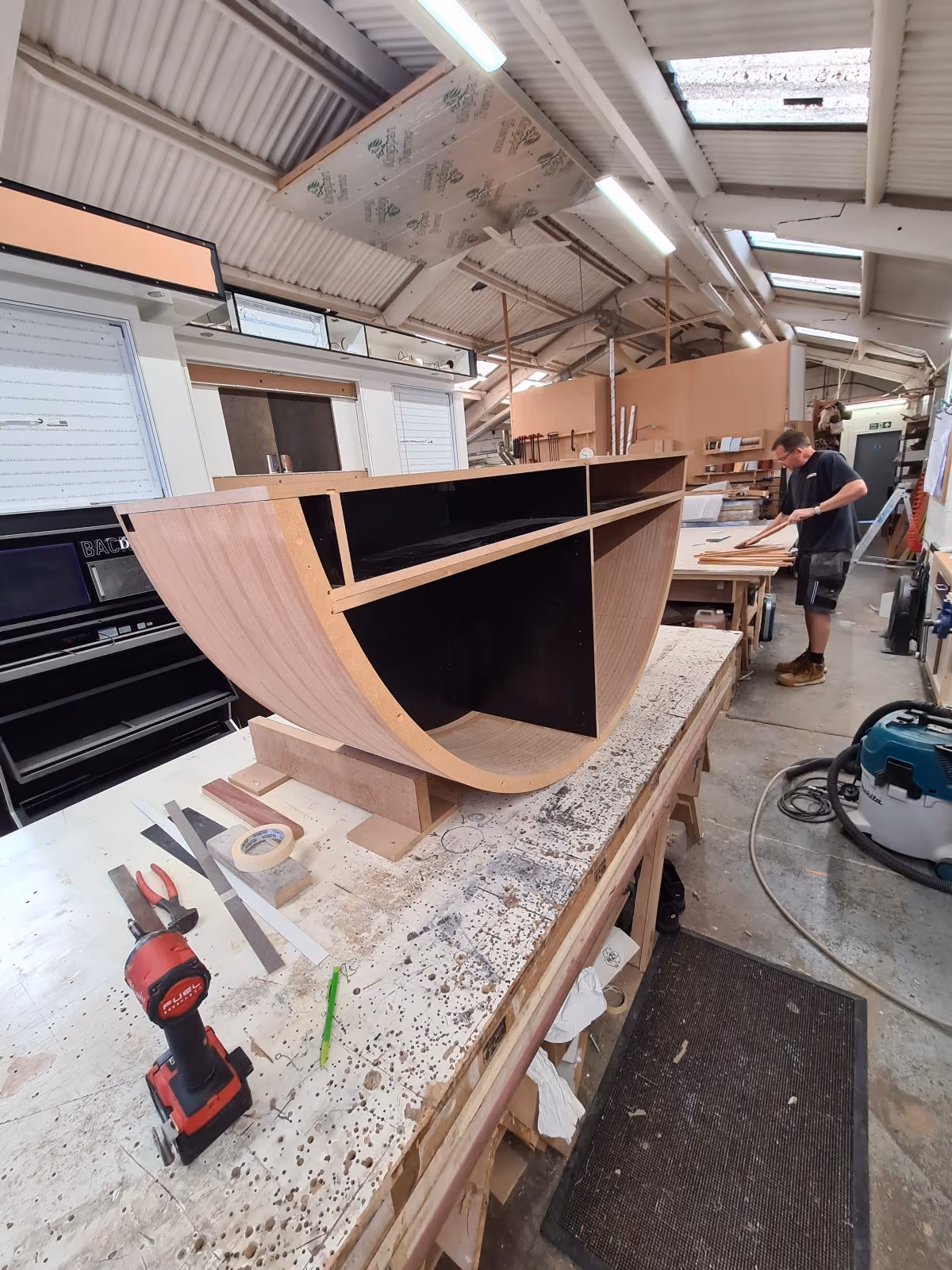 Curved timber base unit being built for the D'Otto display