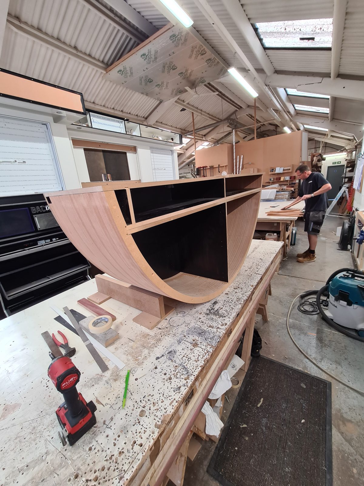 Curved timber base unit being built for the D'Otto display
