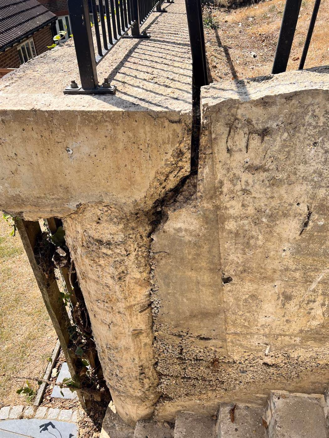 Cracked reinforced concrete capping beam on a piled retaining wall, diagnosed by EMA Structures before engineering-led repair
