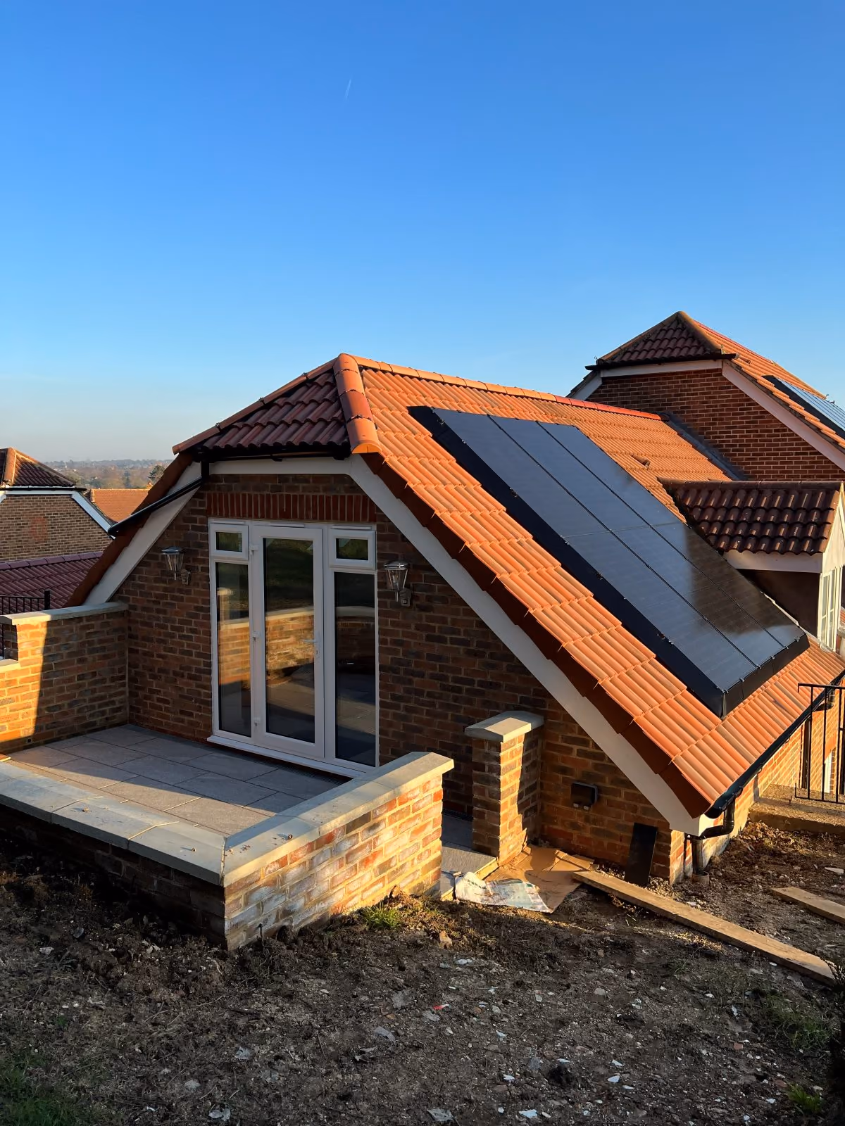 The completed second-floor extension with new roof and solar panels