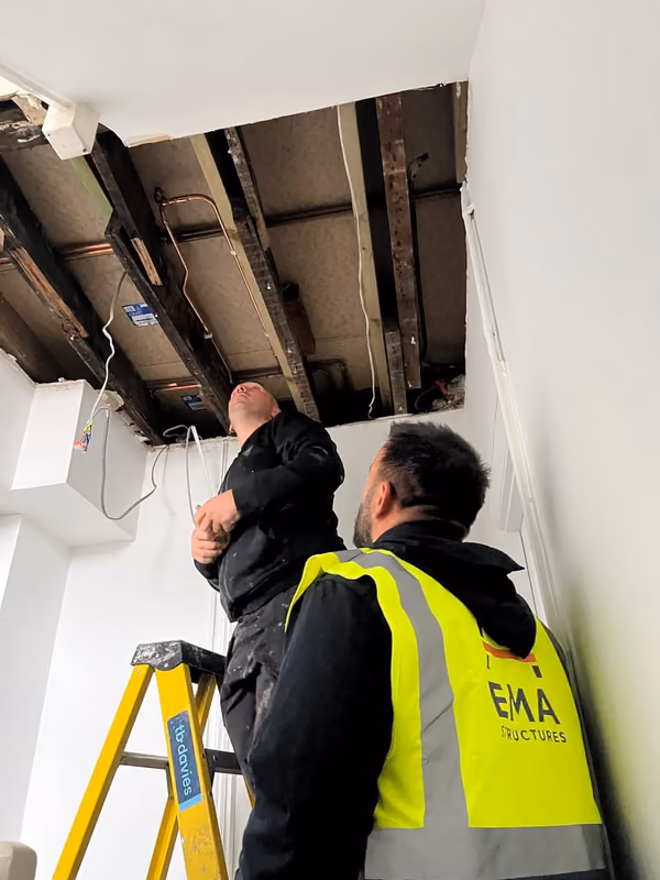 EMA Structures engineer inspecting exposed floor joists after opening up a ceiling in a London property